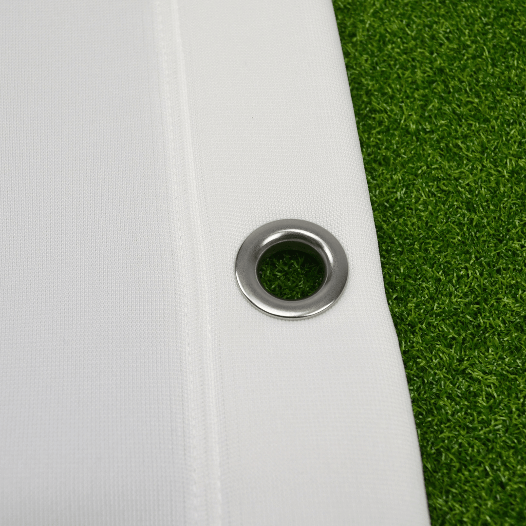 Close up of eyelet on impact screen with green grass underneath