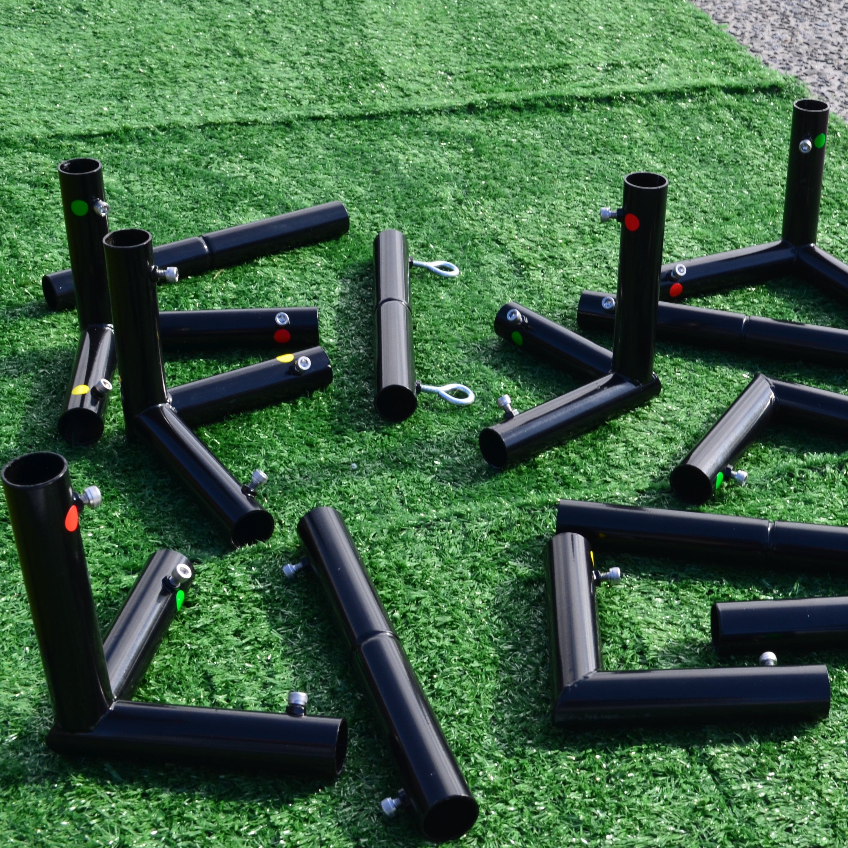 Black corner pieces for Golf Simulator training equipment on a green artificial turf surface