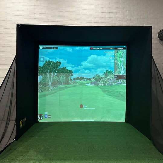 indoor golf simulator with side netting and golf simulator software projected on impact screen
