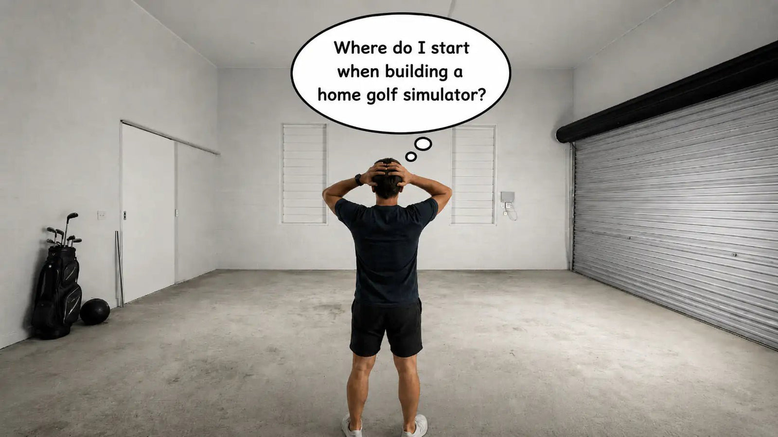 Man stands in front of his empty garage and contemplates how he is going to build a golf simulator