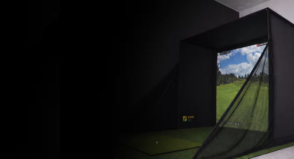 Golf Simulator Enclosure set up in a garage with a golf course displayed on the screen.