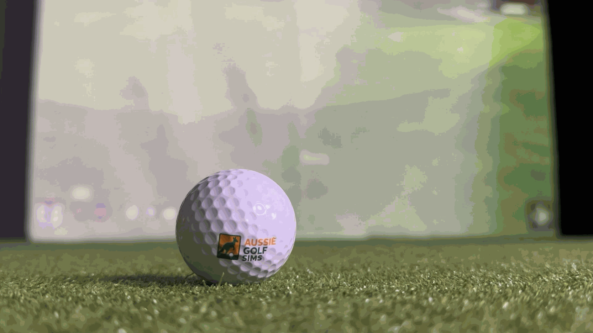 Aussie Golf Sims Golf Ball with Golf Simulator Enclosure in background