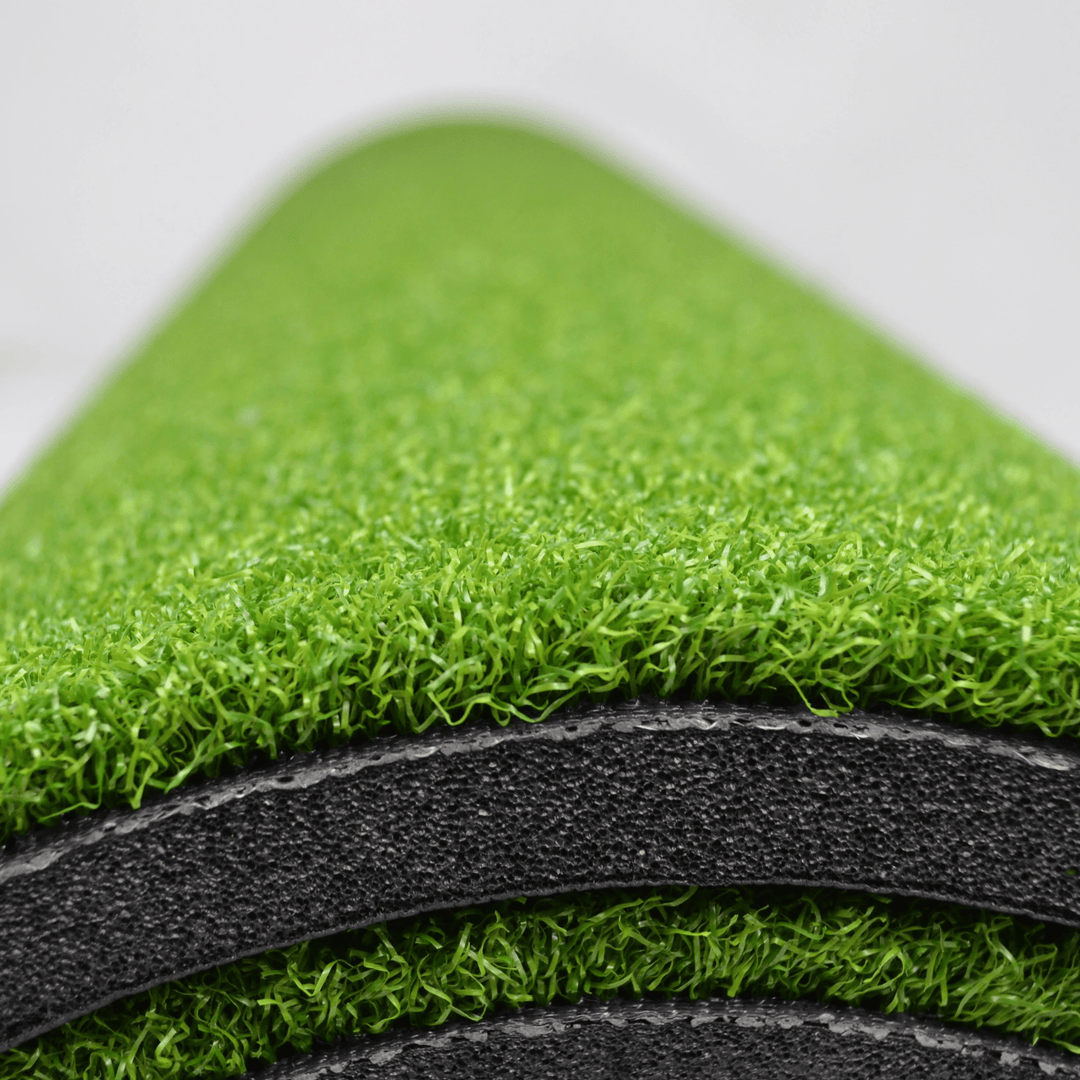 Close-up of golf hitting mat rolled up 