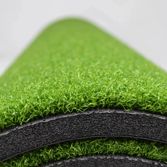 Close-up of golf hitting mat rolled up 