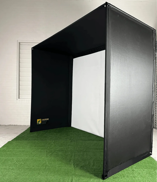 Front-right view of `The RooBox` golf simulator enclosure on green turf