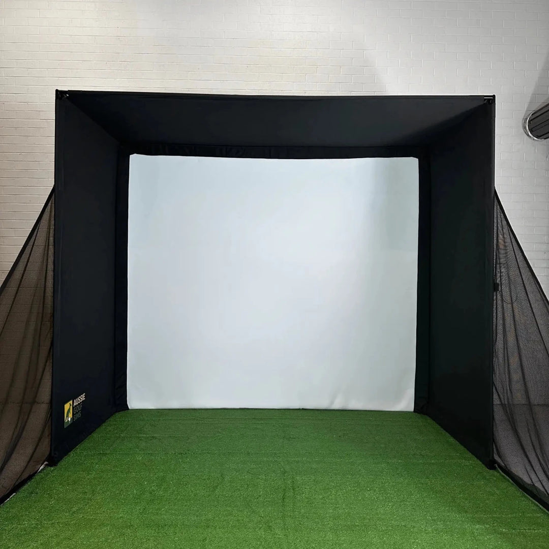 Front view of `The RooBox` golf simulator enclosure on green turf with side-netting fitted