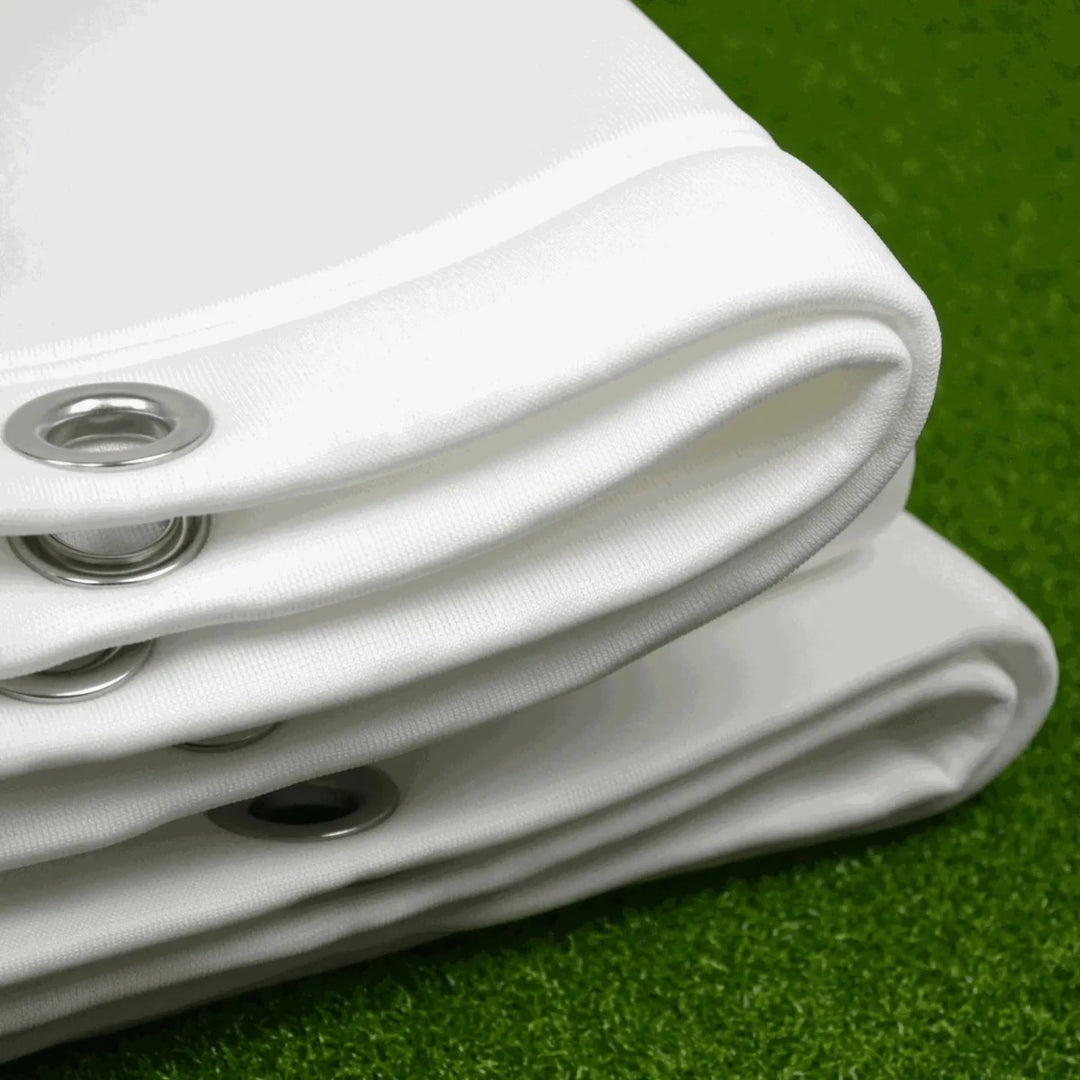 White Golf Impact screen Folded on top of green artificial grass