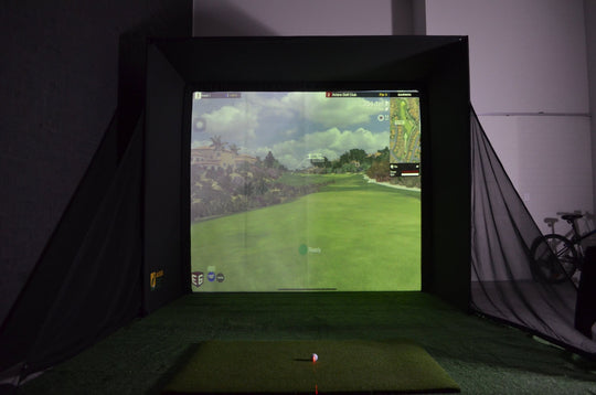 Golf simulator RooBox setup with impact screen displaying a golf course.