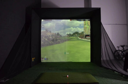 Golf simulator RooBox setup with impact screen displaying a golf course.