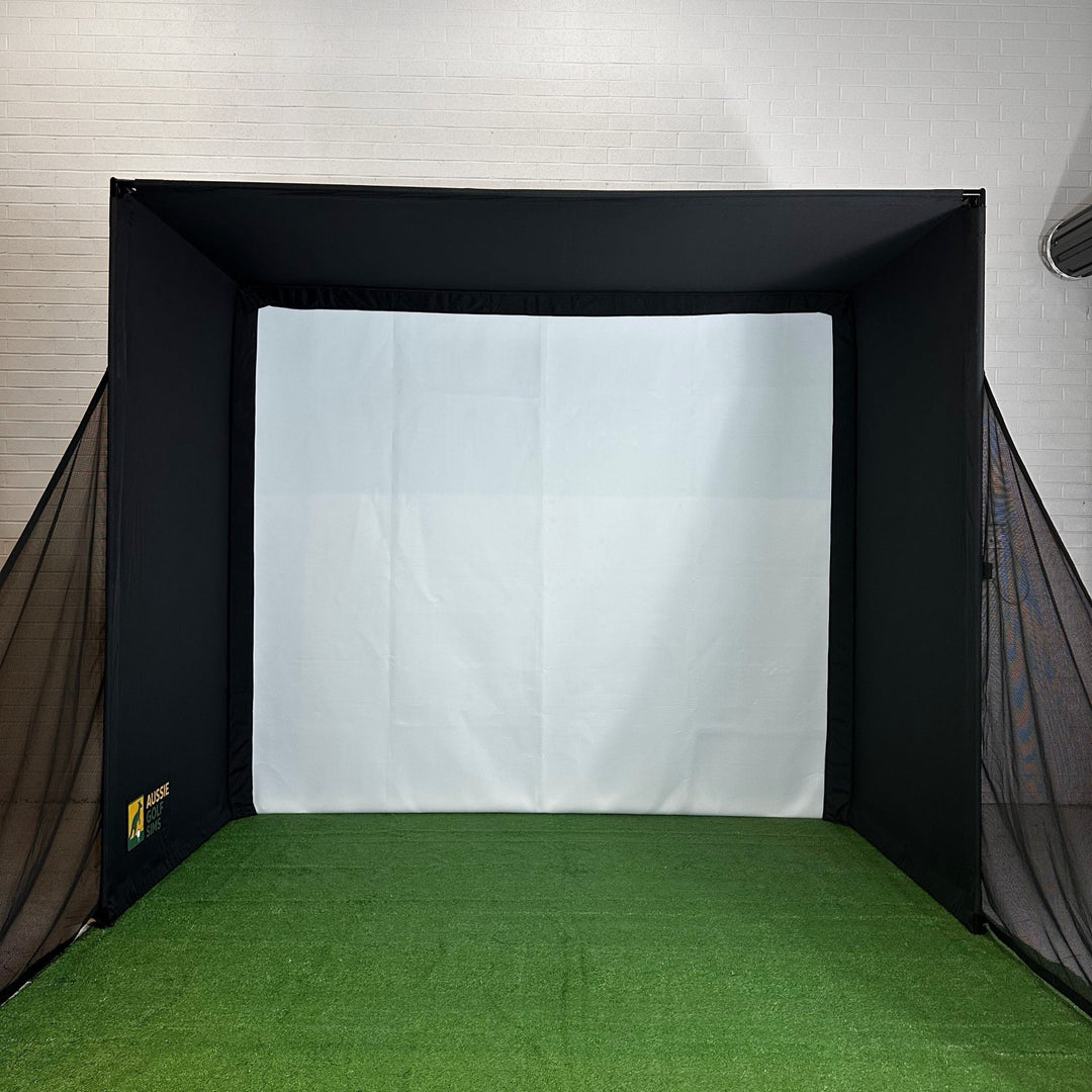Indoor golf sim, with side netting on putting green in room with white walls