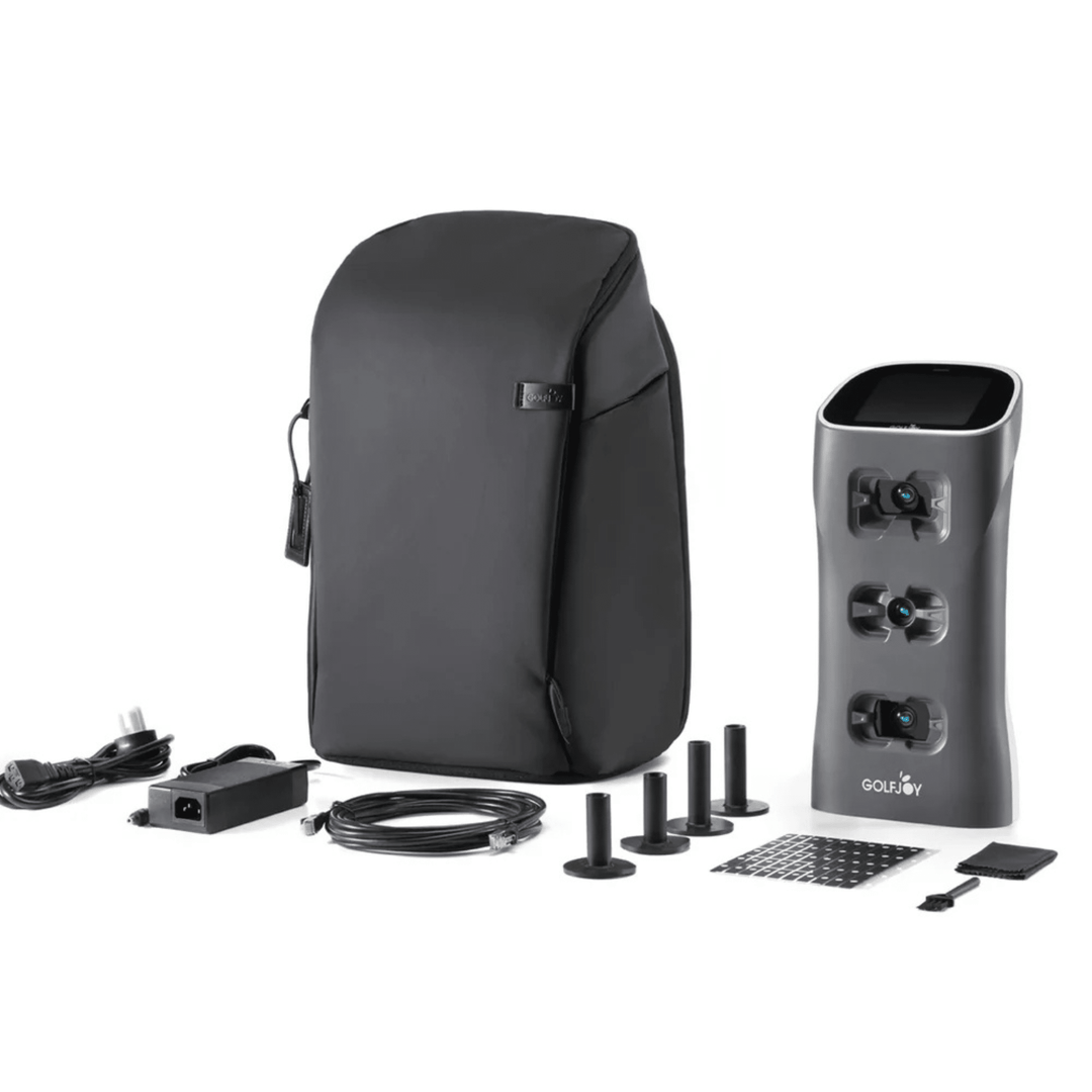 Golf Joy Spica 3 launch monitor in dark gray with black carrying case, power cord, and accessories.