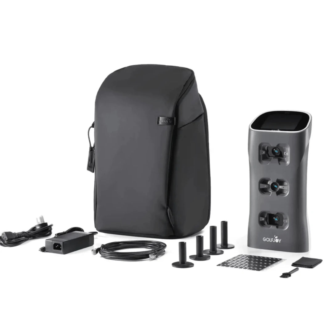 Golf Joy Spica 3 launch monitor in dark gray with black carrying case, power cord, and accessories.
