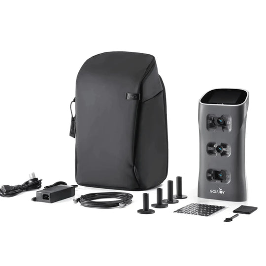 Golf Joy Spica 3 launch monitor in dark gray with black carrying case, power cord, and accessories.