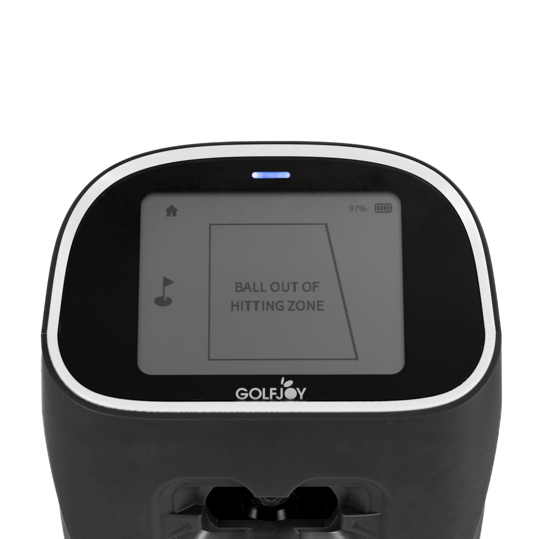 Black Golf Joy Spica 3 launch monitor with a white trim and screen displaying "BALL OUT OF HITTING ZONE".