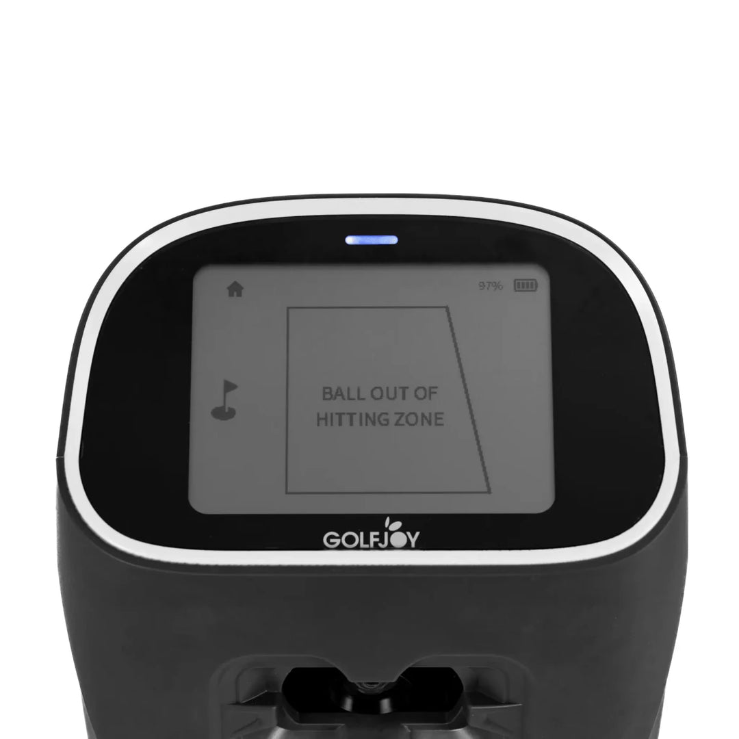 Black Golf Joy Spica 3 launch monitor with a white trim and screen displaying "BALL OUT OF HITTING ZONE".