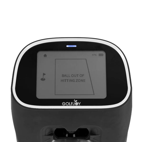 Black Golf Joy Spica 3 launch monitor with a white trim and screen displaying "BALL OUT OF HITTING ZONE".