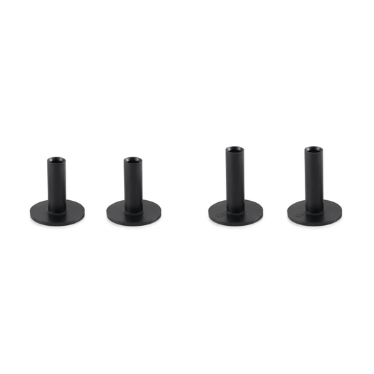 Four black, cylindrical golf tees with flat bases, varying slightly in height.