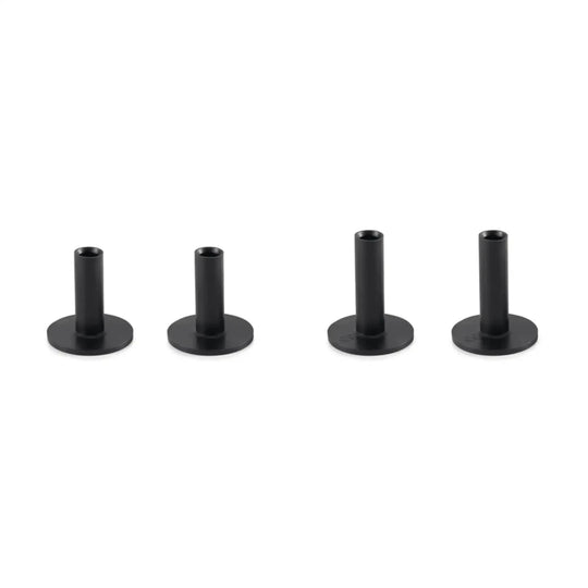 Four black, cylindrical golf tees with flat bases, varying slightly in height.