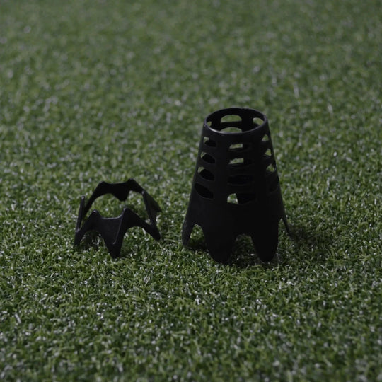 Side by side comparison of short and tall, black indoor golf tees sitting on green golf simulator turf