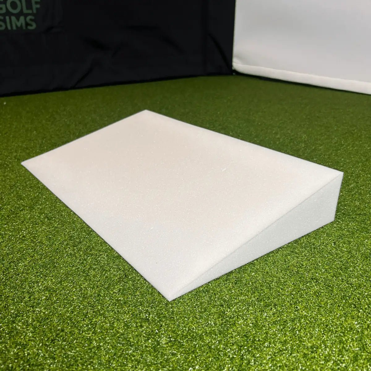 Large White Foam Wedge on Green Golf Simulator Turf