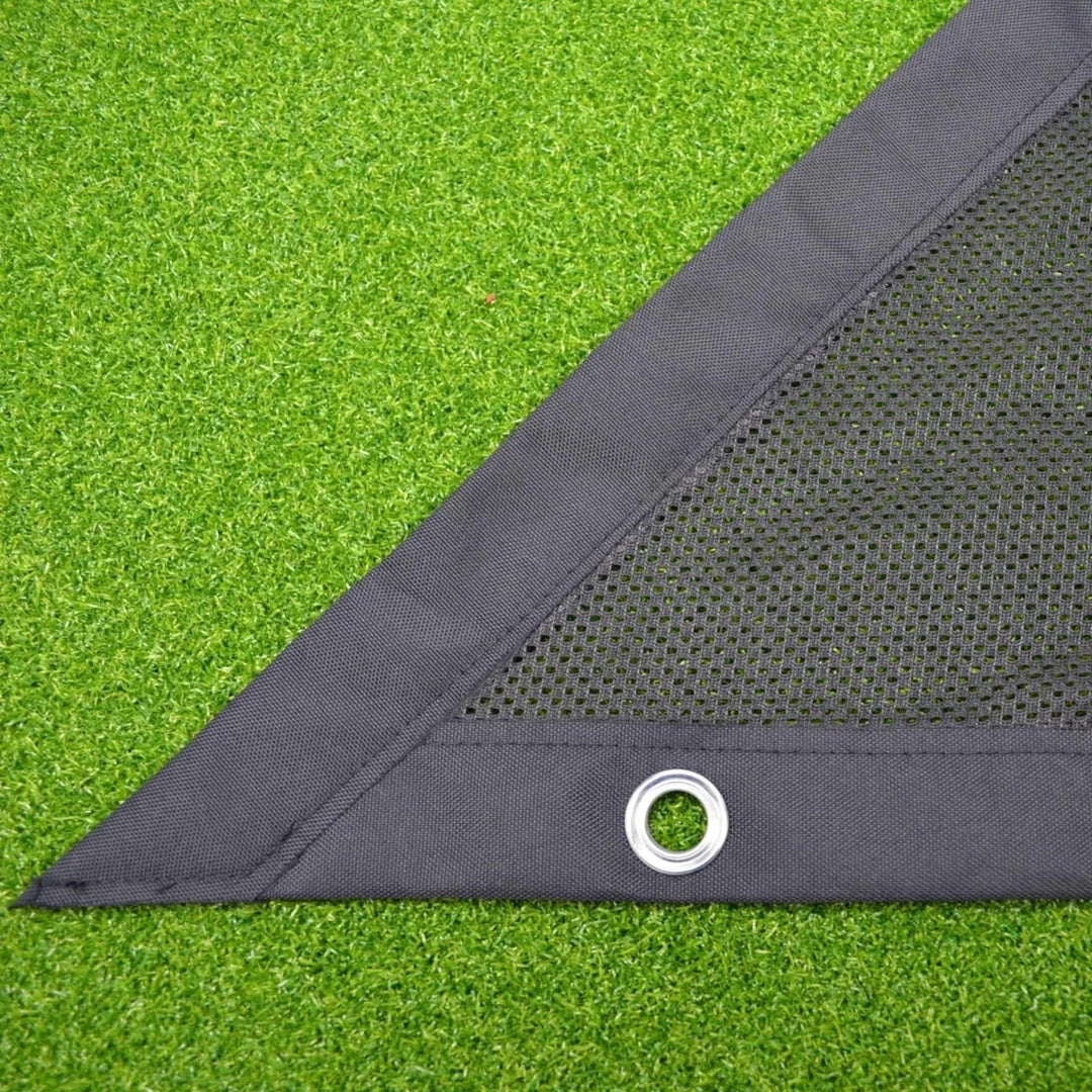 Close up of black side netting on green golf simulator turf