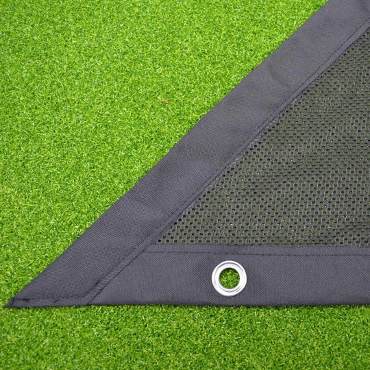 Close up of black side netting on green golf simulator turf