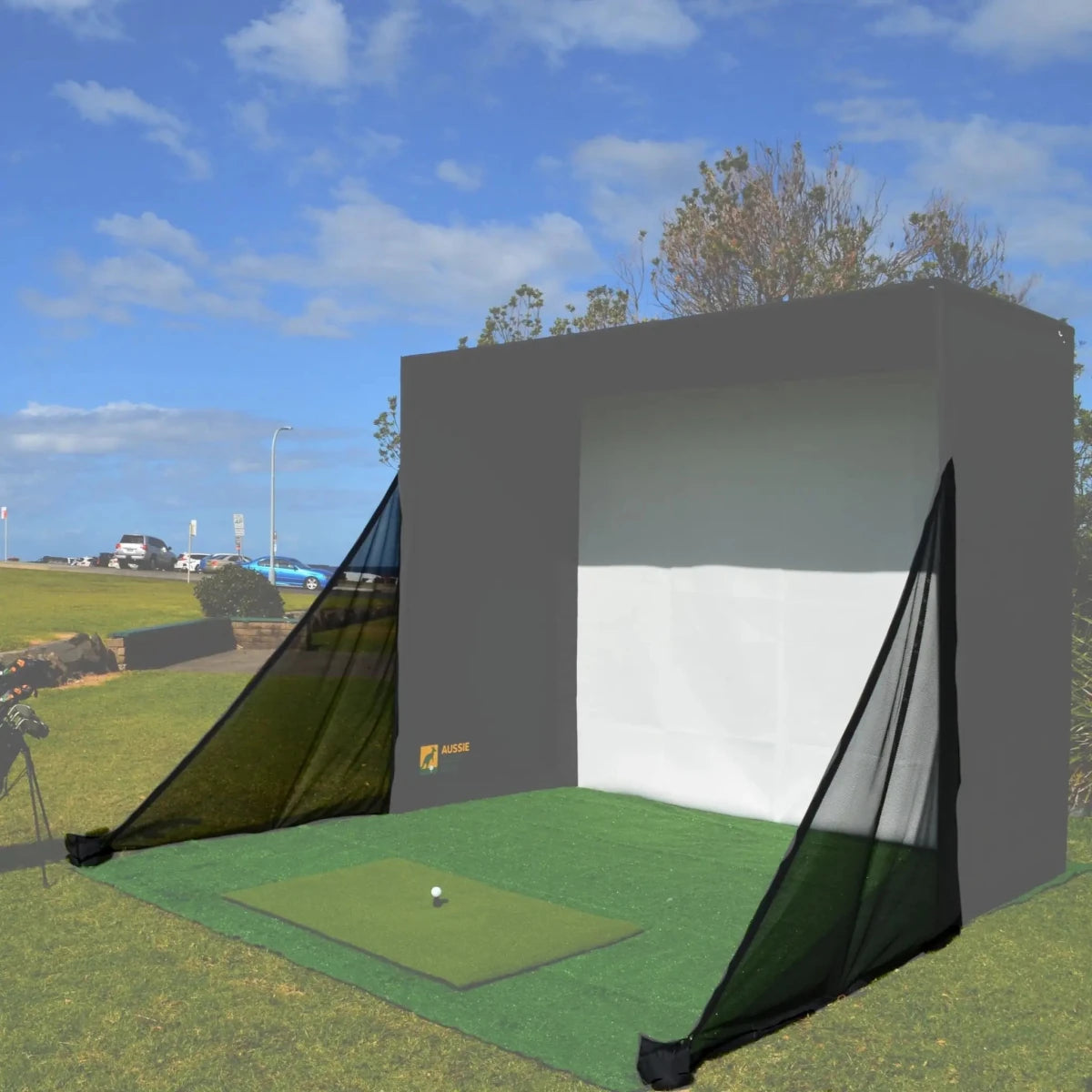 Golf simulator enclosure set up outdoors with black side netting highlighted