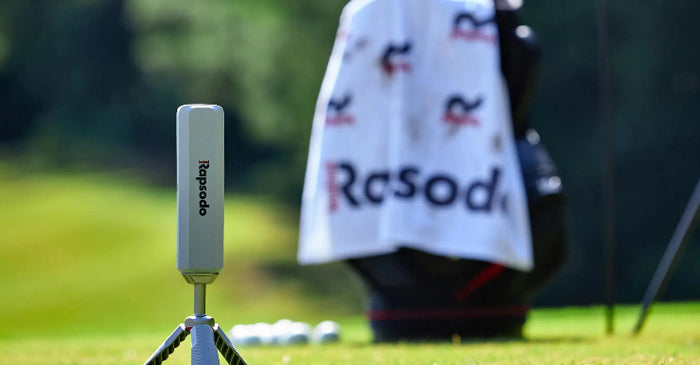 Golf club with a Rapido stand and towel on a golf course
