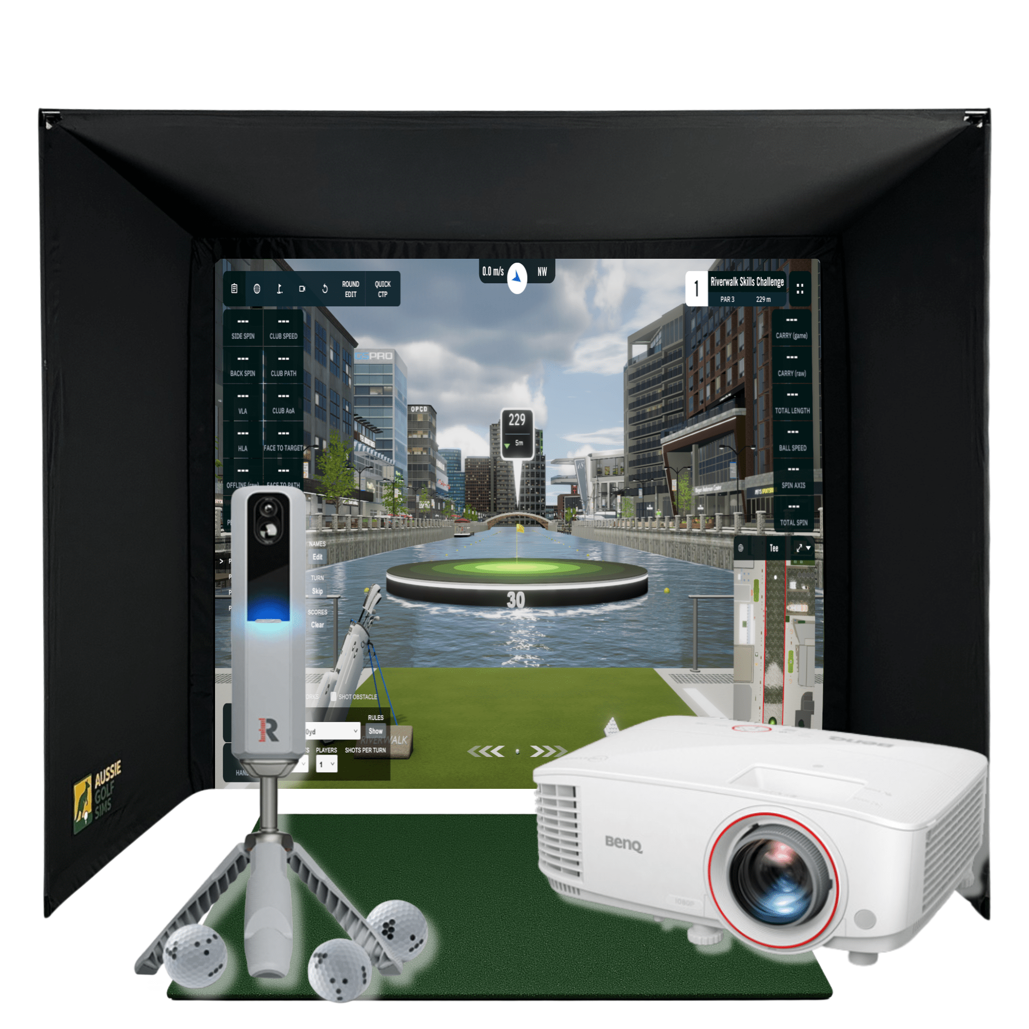 Black golf simulator enclosure with a projected city course, white Rapsodo MLM2Pro, BenQ projector, and golf balls.