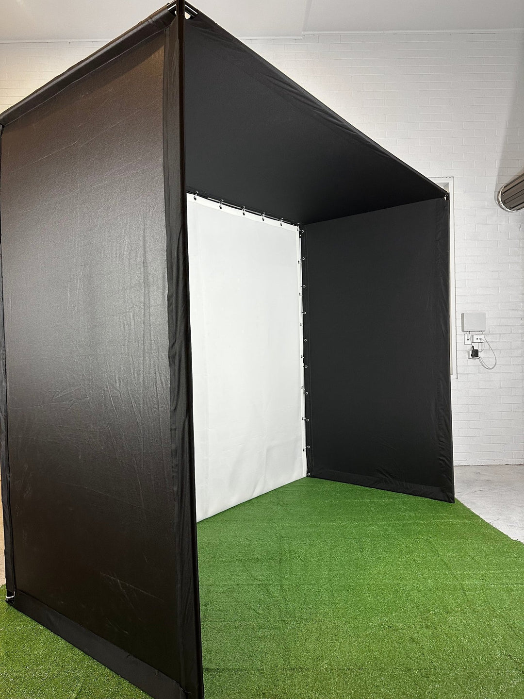 Golf Simulator Enclosure side angle in white walled room