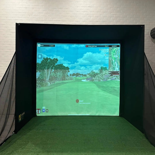 indoor golf simulator with side netting and golf simulator software projected on impact screen
