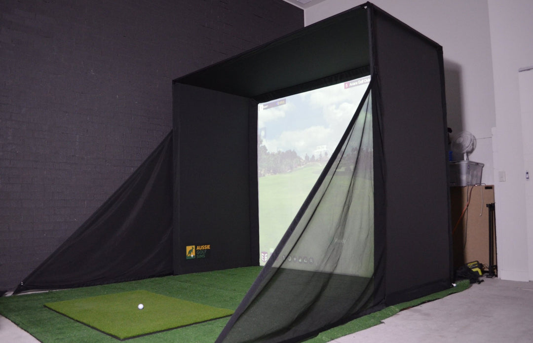 Aussie Golf Sims Golf simulator setup with screen displaying a golf course and ball on the ground.